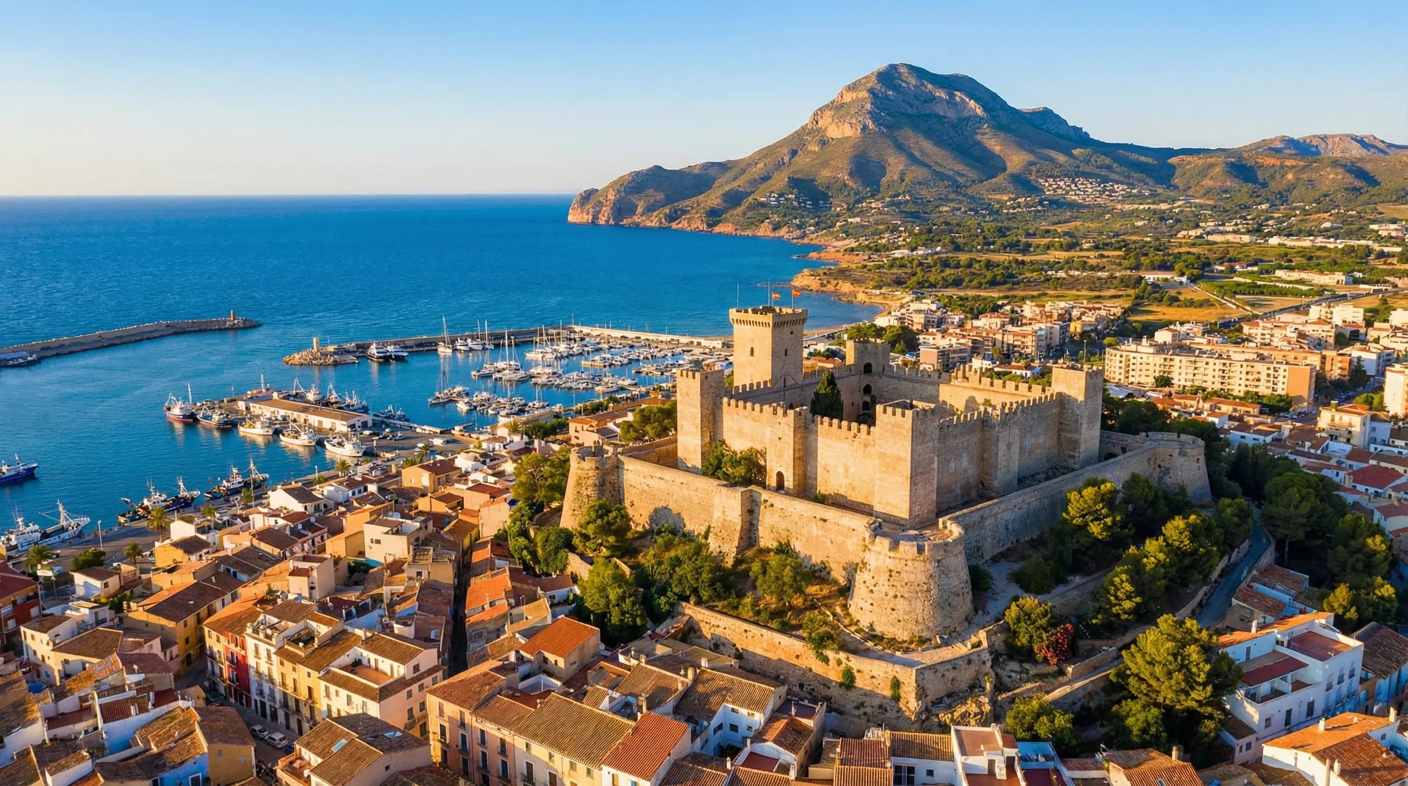 Utsikt över Dénia med slottet på kullen, gamla stan med terrakottafärgade tak och Montgó-berget i bakgrunden, Costa Blanca